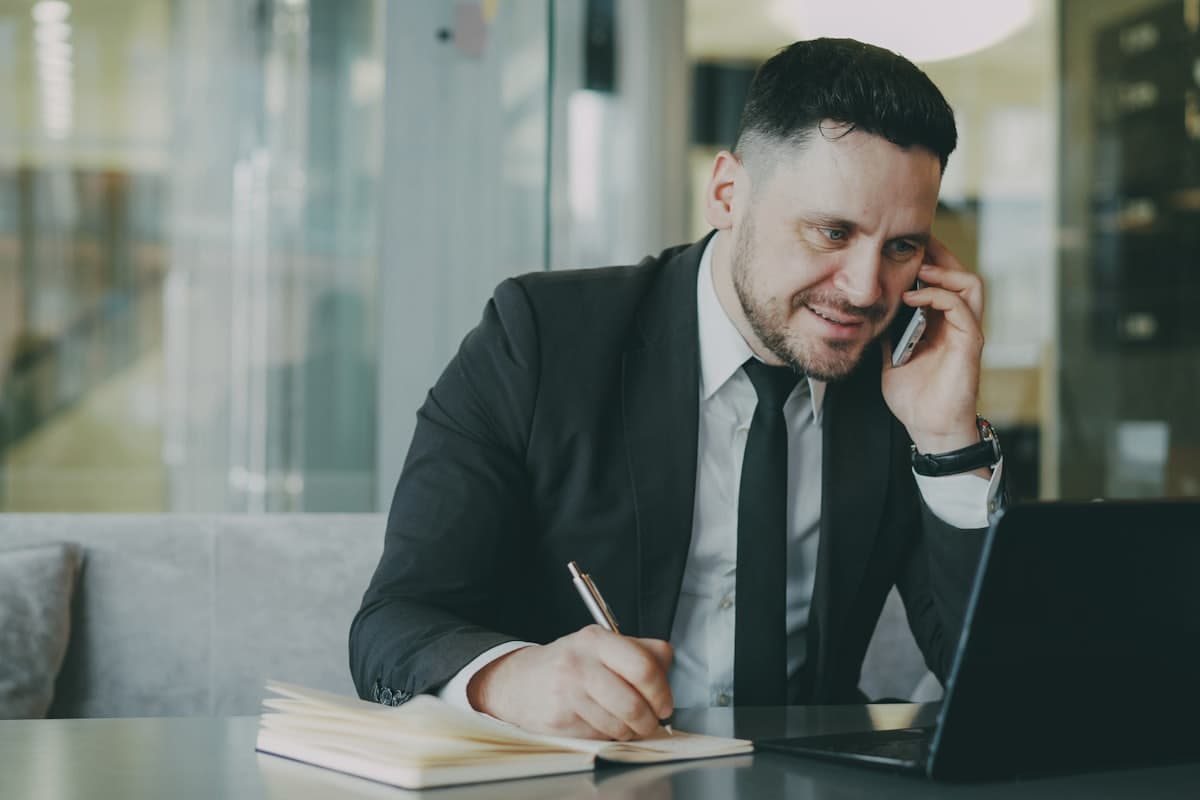 An attorney taking notes during an intake call